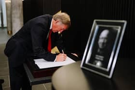 Sir Kenny Dalglish signs the book of condolence for Sir Bobby Charlton at Old Trafford. (Picture: Liverpool FC)