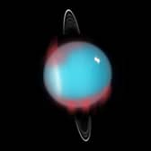 An artist's impression of the newfound infrared aurora superimposed on a Hubble Space Telescope photograph of Uranus. (Image: NASA/ESA/M. Showalter (SETI Institute))