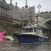 A police boat checks out the 20-metre tall octopus in the Thames (Photo: Kristian Buus / Greenpeace)