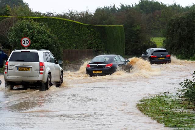 Vehicles travel down a flooded road in Yapton, West Sussex, as Storm Ciaran brings high winds and heavy rain along the south coast of England (Photo: Joe Sene/PA Wire)