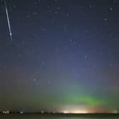 A Taurid meteor over lake Simcoe, Canada, with the aurora borealis shimmering below, on Nov. 9, 2015. (Image credit: Orchidpoet via Getty Images)