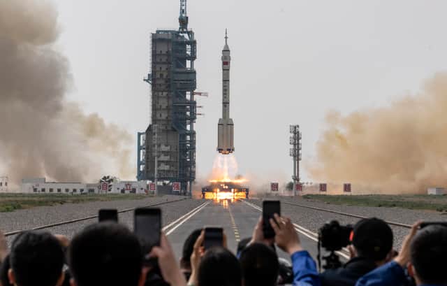 Members from China's Manned Space Agency and visitors watch as the Shenzhou-16 spacecraft onboard the Long March-2F rocket launches at the Jiuquan Satellite Launch Center on May 30, 2023 (Image: Kevin Frayer/Getty Images)
