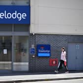 A woman passes a Travelodge in 2020 (Photo: BEN STANSALL/AFP via Getty Images)