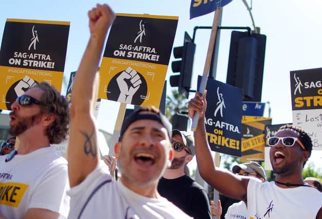 AFTRA members and supporters chant outside Paramount Studios on day 118 of their strike against the Hollywood studios on November 8, 2023 in Los Angeles, California. A tentative labor agreement has been reached between the actors union and the Alliance of Motion Picture and Television Producers (AMPTP) with the strike set to end after midnight. (Photo by Mario Tama/Getty Images)