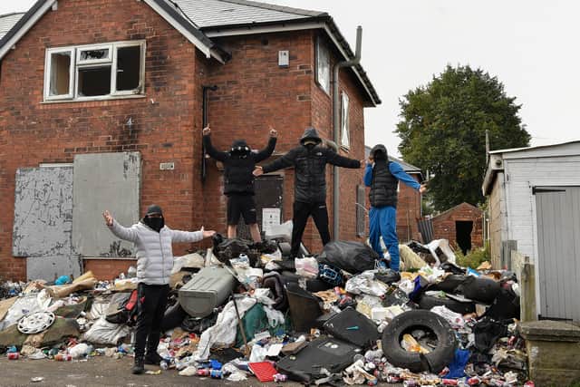 A group of masked youths with faces covered on Dawson Street at a derelict property - Blakenall Heath in Walsall, West Midlands.