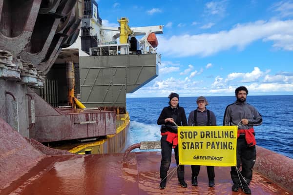 Activists with banner during the  occupation of the Shell oil platform (Photo: Greenpeace/Supplied)