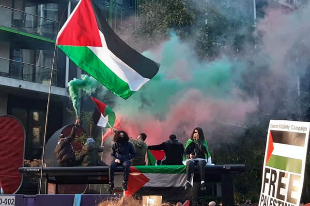 Pro-Palestinian protestors pictured with flares on top of a bus stop. Picture: Amber Allott/NationalWorld