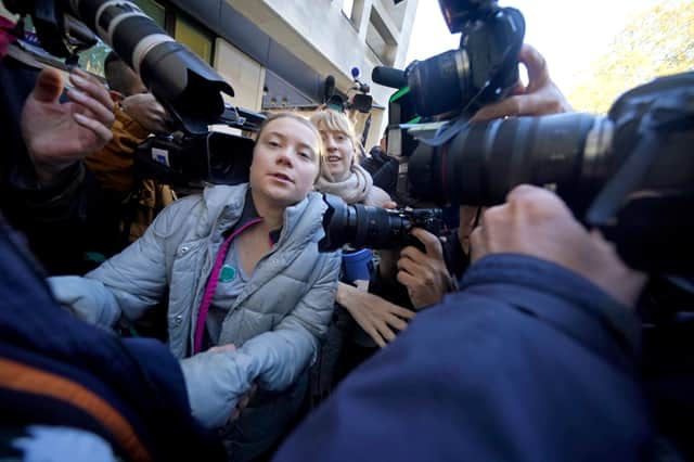 Environmental campaigner Greta Thunberg makes her way through the gathered media as she arrives at Westminster Magistrates' Court in London (Photo: Yui Mok/PA Wire)