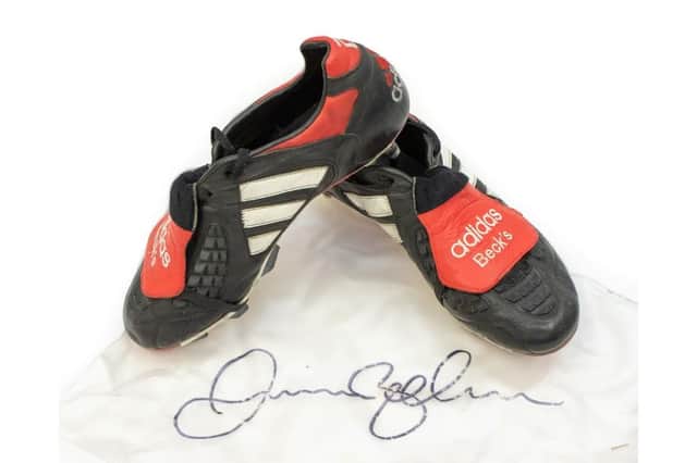 David Beckham's black, white and red Adidas Predator football boots worn in a World Cup 1998 qualifying match (Hansons Auctioneers/ SWNS)