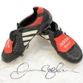 David Beckham's black, white and red Adidas Predator football boots worn in a World Cup 1998 qualifying match (Hansons Auctioneers/ SWNS)