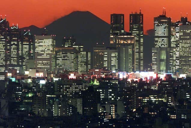 Japan's highest Mountain, Fuji, shown up in the sunset behind Tokyo's Shinjuku skyscraper (Credit: Getty)