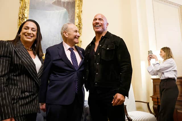 U.S. Majority Leader Chuck Schumer (D-NY) poses for photos with actor Dwayne Johnson (R) and XFL Co-Owner and CEO Dany Garcia (L) in his office at the U.S. Capitol Building on November 15, 2023 in Washington, DC. (Photo by Anna Moneymaker/Getty Images)
