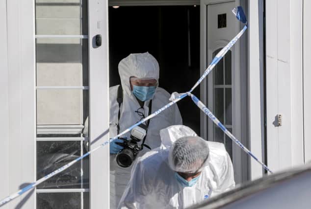 Police and forensic officers at the home in Dovey Road, Moseley, Birmingham, after the newborn baby died