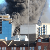 A huge fire broke out at a high-rise in Reading with a workman rescued from a nearby roof. (Credit: @tomcanning83/X)
