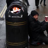Crisis are looking for volunteers this Christmas. A person sits on the pavement, begging in central London on October 20, 2023. Photograph by Getty