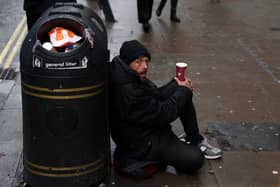 Crisis are looking for volunteers this Christmas. A person sits on the pavement, begging in central London on October 20, 2023. Photograph by Getty