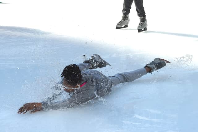 An ice skater falls (Photo: TIMOTHY A. CLARY/AFP via Getty Images)