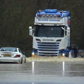 A lorry and car caught in flooding in Chard in Somerset. Picture: Paul Silvers/SWNS