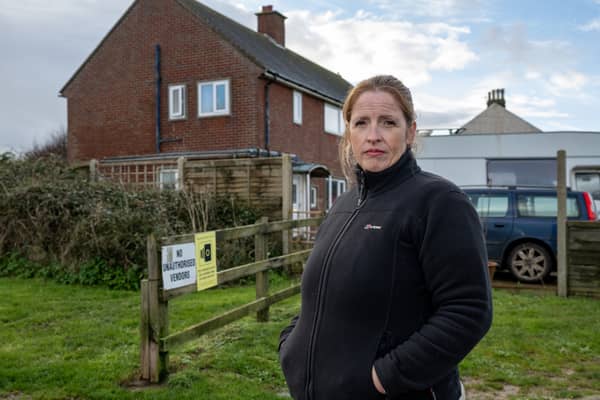 Nicola Bayless, 48, outside her home in Happisburgh, Norfolk, which she thinks may be lost to coastal erosion (SWNS)