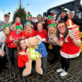 Joey Muller, aged six, and mum Paige (front) along with staff at Briggs UK, Cannock, who star in a Christmas video they have created that rivals John Lewis and M&S videos. (Credit: Briggs Equipment UK)