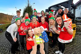 Joey Muller, aged six, and mum Paige (front) along with staff at Briggs UK, Cannock, who star in a Christmas video they have created that rivals John Lewis and M&S videos. (Credit: Briggs Equipment UK)