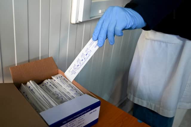 A medical staff member grabs a test for whooping cough (Image: DENIS LOVROVIC/AFP via Getty Images)