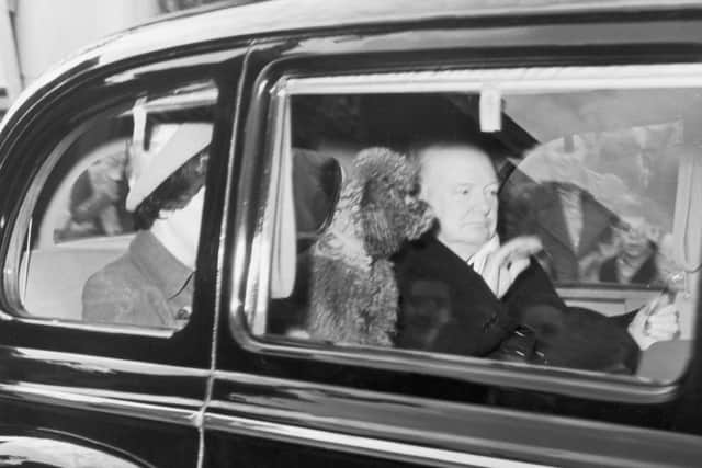 Winston Churchill leaving Buckingham Palace, accompanied by his poodle Rufus on  25th September 1951. Photograph by Getty