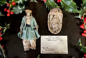 Queen Victoria Christmas decoration of a small doll inside a woven crib and and a wax doll (Hansons Auctioneers / SWNS)