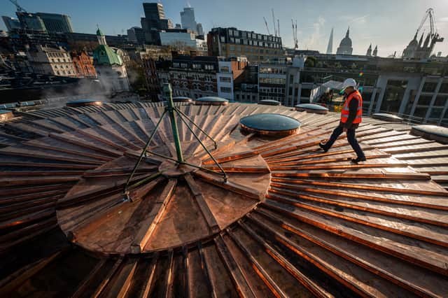 Chris Johnson, 82, who worked on the roof at Smithfield Market in London, as an apprentice in the 60s, walks across the refurbished copper clad Poultry Market roof, where the new Museum of London will be rehomed (Aaron Chown/PA Wire)