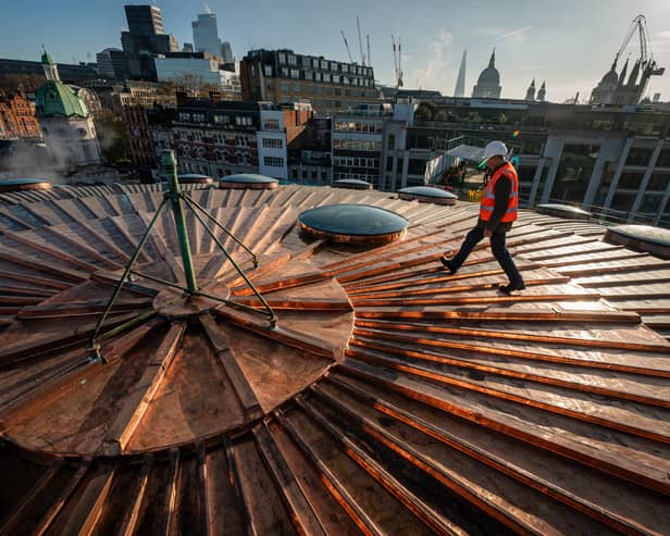 Chris Johnson, 82, who worked on the roof at Smithfield Market in London, as an apprentice in the 60s, walks across the refurbished copper clad Poultry Market roof, where the new Museum of London will be rehomed (Aaron Chown/PA Wire)