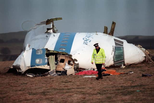 A policeman walks away from the cockpit of the 747 Pan Am airliner that exploded and crashed over Lockerbie, Scotland, 22 December 1988. 