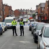 Police at the scene of a shooting on Page Hall Road, Sheffield, after which a teenager has died