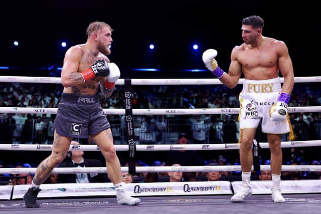 Jake Paul looks on as Tommy Fury taunts them during the Cruiserweight Title fight in Riyadh, Saudi Arabia