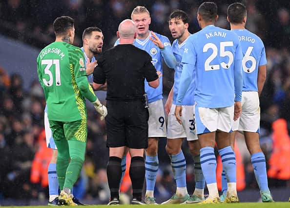 Manchester City striker Erling Haaland and team mates have words with Referee Simon Hooper during the Premier League match between Manchester City and Tottenham Hotspur at Etihad Stadium on December 03, 2023 in Manchester, England. (Photo by Stu Forster/Getty Images)