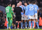 Manchester City striker Erling Haaland and team mates have words with Referee Simon Hooper during the Premier League match between Manchester City and Tottenham Hotspur at Etihad Stadium on December 03, 2023 in Manchester, England. (Photo by Stu Forster/Getty Images)
