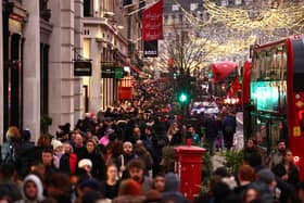 Christmas shoppers on Regent Street in London (Photo: HENRY NICHOLLS/AFP via Getty Images)