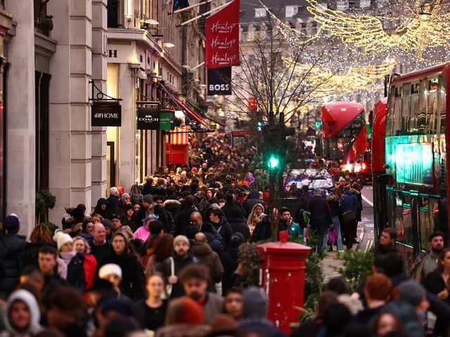 Christmas shoppers on Regent Street in London (Photo: HENRY NICHOLLS/AFP via Getty Images)
