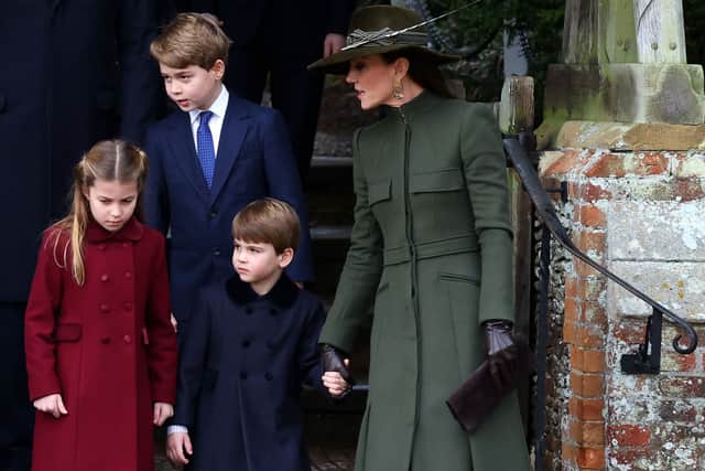 For Christmas Day, 2022, Catherine, Princess of Wales (pictured  with Prince George, Princess Charlotte and Prince Louis) wore a green Alexander McQueen coat. Photograph by Getty