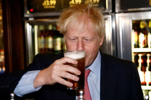 Boris Johnson with a pint of beer. One of his big Brexit dividends - the return to imperial measures - has been scrapped by the government. Credit: Getty