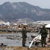 Japanese Self Defence Force soldiers prepare for the rescue work at Otsuchi town, Iwate prefecture on March 17, 2011 following the March 11 earthquake and tsunami. The official number of dead and missing after a devastating earthquake and tsunami that flattened Japan's northeast coast is nearing 15,000, police said on March 17.  AFP PHOTO / TOSHIFUMI KITAMURA (Photo by TOSHIFUMI KITAMURA / AFP) 