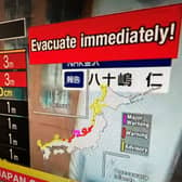 This image taken in Hong Kong on January 1, 2024 shows a warning message on a screen from a live feed on NHK World asking people to evacuate from the area after a series of major earthquakes hit central Japan. A powerful 7.5 earthquake hit central Japan on January 1, the USGS said, prompting tsunami warnings and authorities to urge people in the area to move to higher ground. (Photo by Mladen ANTONOV / AFP) 