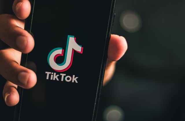 17 slang TikTok terms, including abbreviations and acronyms, explained including moots, OOMF, 1437 and bussin. Stock image by Adobe Photos.