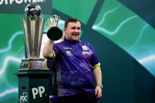 Luke Littler celebrates with the runner-up trophy after the 2023/24 Paddy Power World Darts Championship Final (Photo: Tom Dulat/Getty Images)