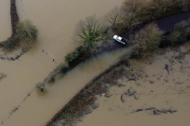 A van avoids flood water from the River Ouse in Barcombe Mills, East Sussex. Credit: Gareth Fuller/PA Wire