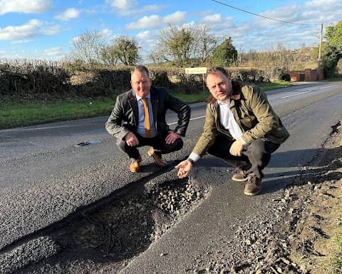Councillor David Martin (left) and Jason Zadrozny (right) next to the huge pothole in Flatts Lane, Westwood 