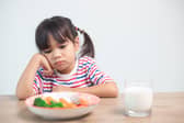 Kids really do take after their parents - so smile next time you're eating your greens! (Picture: Adobe Stock)