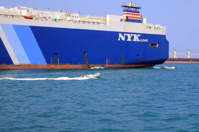 A picture taken during an organised tour by Yemen's Huthi rebels on November 22, 2023 shows the Galaxy Leader cargo ship (R), seized by Huthi fighters two days earlier, docked at a port on the Red Sea in Yemen's province of Hodeida. Credit: Getty/AFP