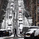 People walk up Gardner street in Glasgow as snow blankets the city (Photo: ANDY BUCHANAN/AFP via Getty Images)