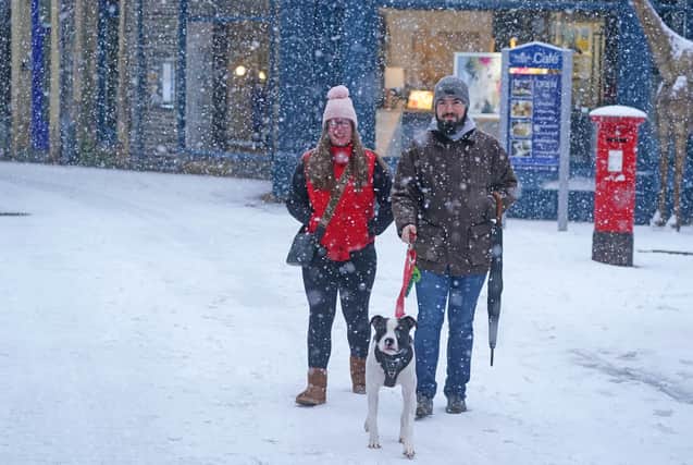 People walking in the snow in Keswick in Cumbria. Picture: Owen Humphreys/PA Wire 