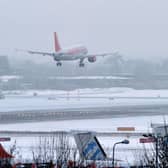 Can passengers get a refund if their flight is cancelled due to bad weather - we explain as UK record coldest night of winter so far. (Photo: AFP via Getty Images)